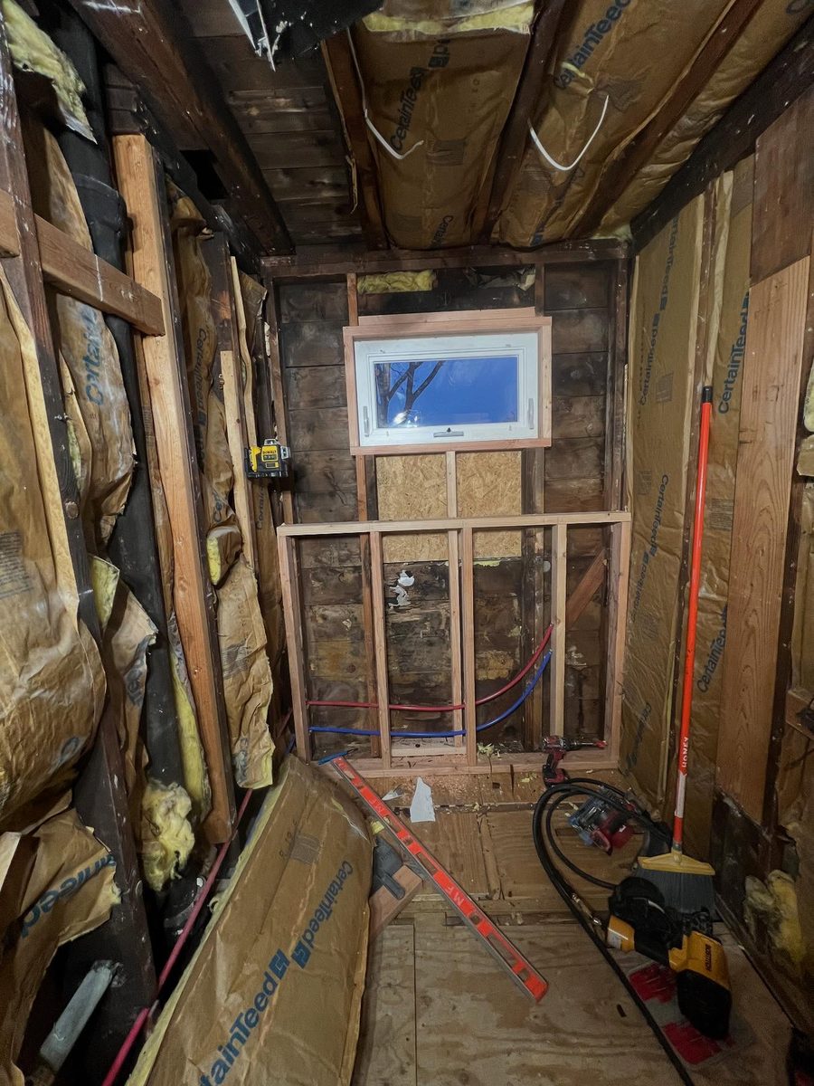 Bathroom renovation in progress showing framing and plumbing rough-in