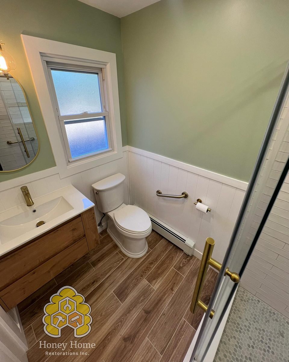 Beautiful sage green bathroom remodel on Long Island by Honey Home Restorations